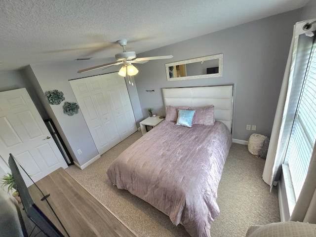 5237 NW Milner Dr, Port Saint Lucie, FL 34983 - carpeted bedroom featuring multiple windows, baseboards, ceiling fan, a textured ceiling, and a closet