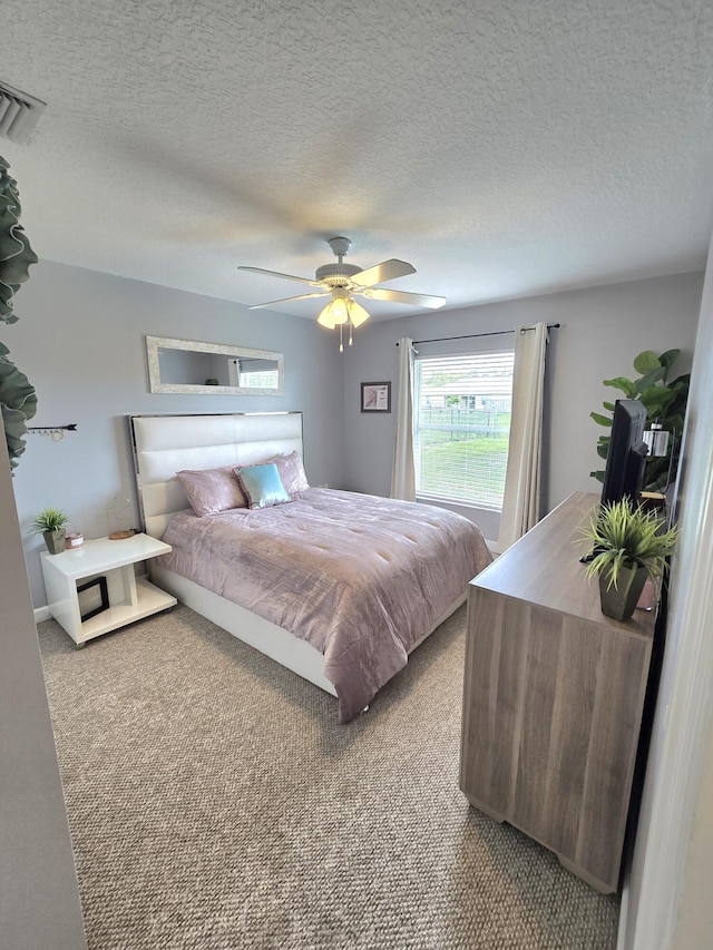 5237 NW Milner Dr, Port Saint Lucie, FL 34983 - bedroom featuring light carpet, a ceiling fan, and a textured ceiling
