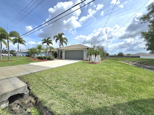 5237 NW Milner Dr, Port Saint Lucie, FL 34983 - view of front of property featuring a garage, concrete driveway, and a front lawn