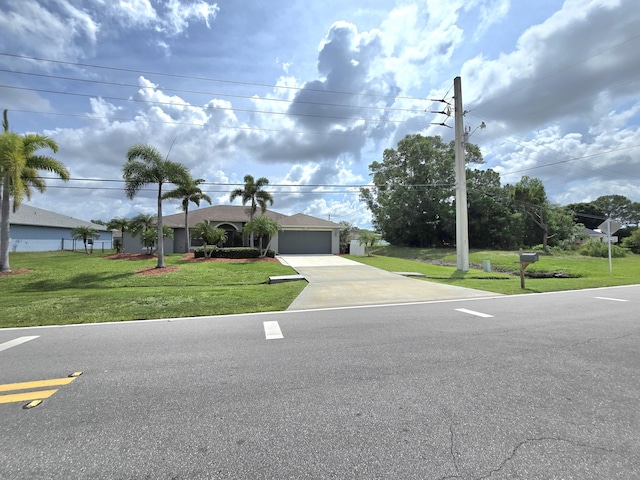5237 NW Milner Dr, Port Saint Lucie, FL 34983 - ranch-style house featuring driveway, a front yard, and an attached garage