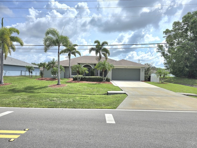5237 NW Milner Dr, Port Saint Lucie, FL 34983 - single story home with concrete driveway, a garage, and a front yard