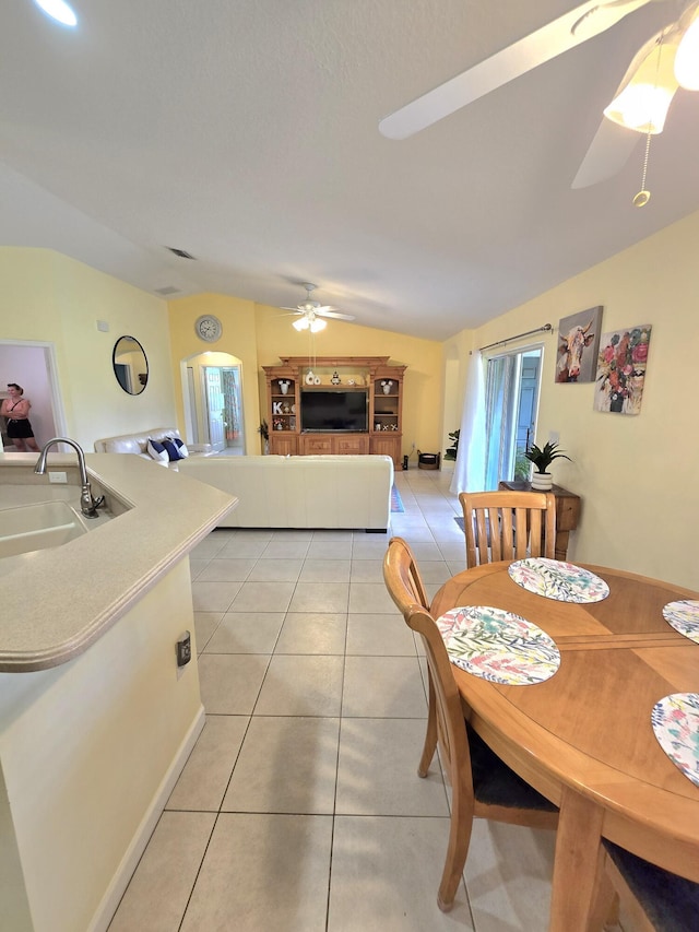 5237 NW Milner Dr, Port Saint Lucie, FL 34983 - dining room featuring vaulted ceiling, a ceiling fan, and light tile patterned floors