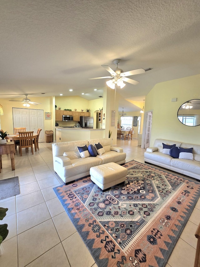 5237 NW Milner Dr, Port Saint Lucie, FL 34983 - living room featuring a ceiling fan, light tile patterned floors, and a textured ceiling