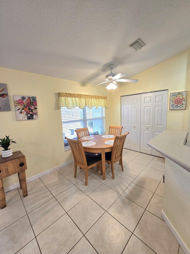 5237 NW Milner Dr, Port Saint Lucie, FL 34983 - dining room featuring a ceiling fan, light tile patterned floors, baseboards, and lofted ceiling