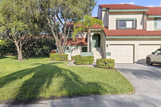 23 Lexington Ln W Unit A, Palm Beach Gardens, FL 33418 - view of front of house with a garage, a front lawn, and stucco siding