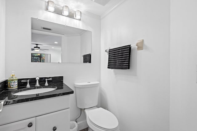23 Lexington Ln W Unit A, Palm Beach Gardens, FL 33418 - half bath featuring ornamental molding, toilet, vanity, ceiling fan, and baseboards