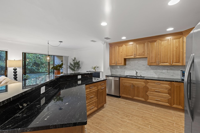 23 Lexington Ln W Unit A, Palm Beach Gardens, FL 33418 - kitchen featuring stainless steel appliances, a sink, decorative backsplash, ornamental molding, and dark stone countertops