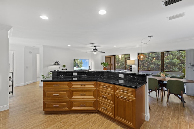 23 Lexington Ln W Unit A, Palm Beach Gardens, FL 33418 - kitchen with light wood-type flooring, ceiling fan, decorative light fixtures, recessed lighting, and brown cabinets