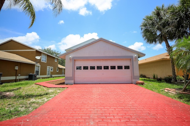 1356 N Climbing Rose, West Palm Beach, FL 33415 - view of front of home featuring stucco siding, decorative driveway, central AC, and a front lawn