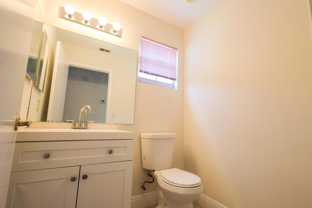 1356 N Climbing Rose, West Palm Beach, FL 33415 - bathroom featuring toilet, baseboards, and vanity