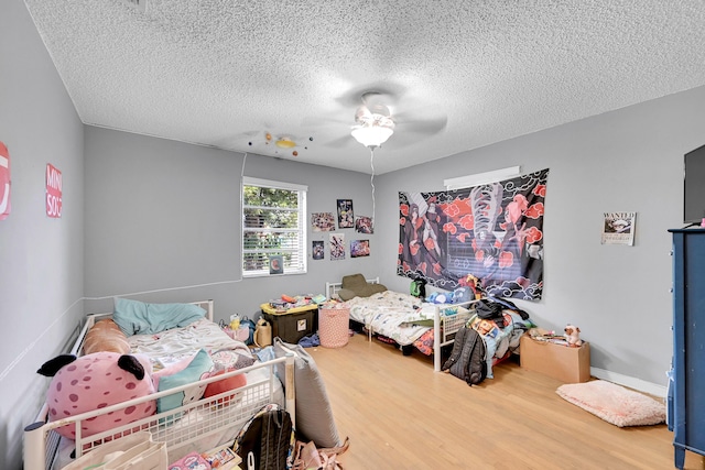 1331 S Palmway, Lake Worth Beach, FL 33460 - bedroom featuring wood finished floors, a textured ceiling, and a ceiling fan