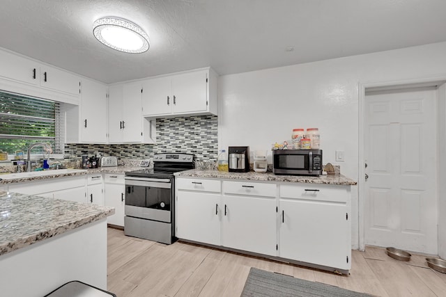 1331 S Palmway, Lake Worth Beach, FL 33460 - kitchen featuring stainless steel appliances, a sink, light wood-type flooring, and decorative backsplash