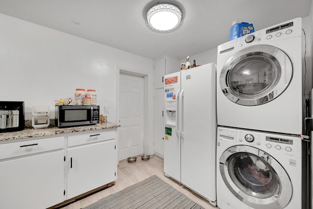 1331 S Palmway, Lake Worth Beach, FL 33460 - washroom with estacked washer and dryer and light wood-style floors