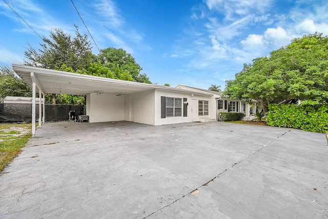 1331 S Palmway, Lake Worth Beach, FL 33460 - view of front of house featuring stucco siding, a carport, and concrete driveway