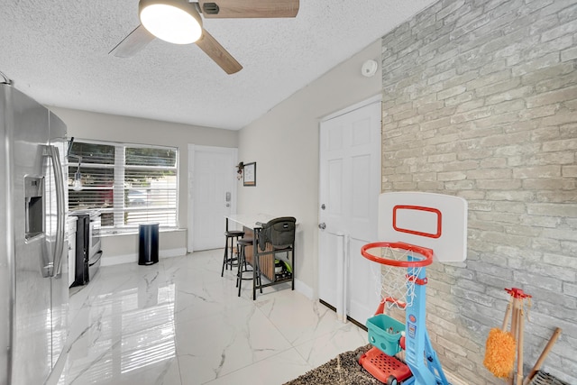 1331 S Palmway, Lake Worth Beach, FL 33460 - playroom featuring light marble finish flooring, a textured ceiling, ceiling fan, and baseboards