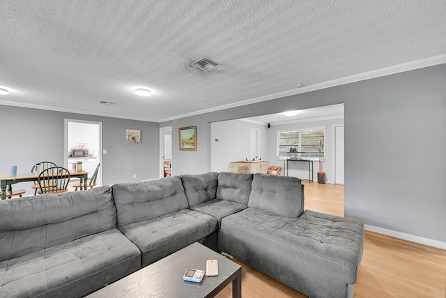 1331 S Palmway, Lake Worth Beach, FL 33460 - living room featuring light wood-style floors, crown molding, a textured ceiling, and baseboards