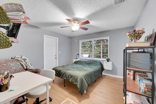 1331 S Palmway, Lake Worth Beach, FL 33460 - bedroom featuring light wood finished floors, a textured ceiling, a ceiling fan, and baseboards