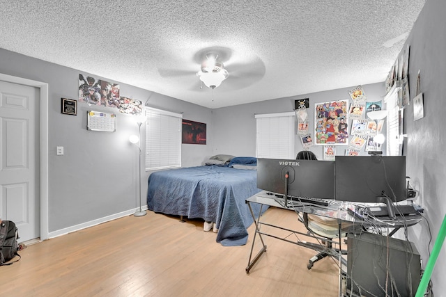1331 S Palmway, Lake Worth Beach, FL 33460 - bedroom featuring wood finished floors, a textured ceiling, a ceiling fan, a desk, and baseboards