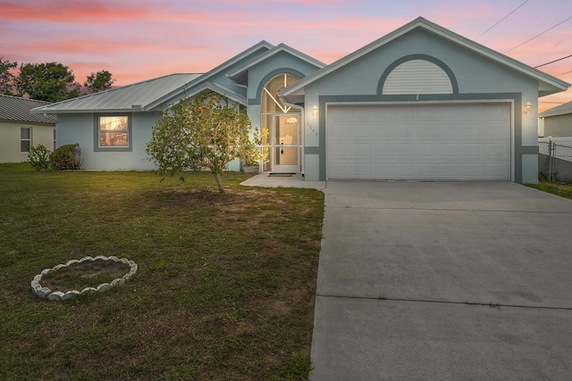 3048 SE Wake Rd, Port Saint Lucie, FL 34984 - ranch-style house featuring stucco siding, concrete driveway, a lawn, and a garage