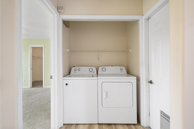 3048 SE Wake Rd, Port Saint Lucie, FL 34984 - laundry room with separate washer and dryer, baseboards, and light colored carpet
