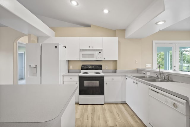 3048 SE Wake Rd, Port Saint Lucie, FL 34984 - kitchen featuring white appliances, a sink, lofted ceiling, light countertops, and white cabinets