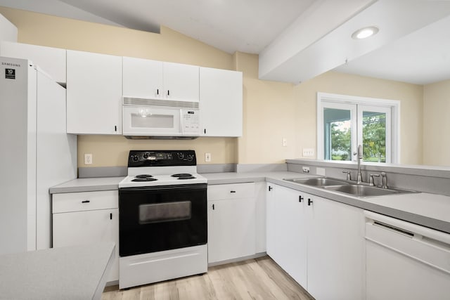 3048 SE Wake Rd, Port Saint Lucie, FL 34984 - kitchen featuring white appliances, a sink, vaulted ceiling, light countertops, and light wood-type flooring