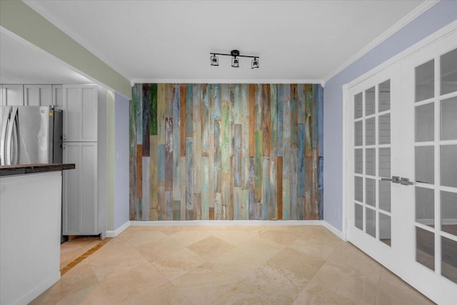 104 Paradise Harbour Blvd Unit 104, North Palm Beach, FL 33408 - unfurnished dining area featuring french doors, ornamental molding, and baseboards