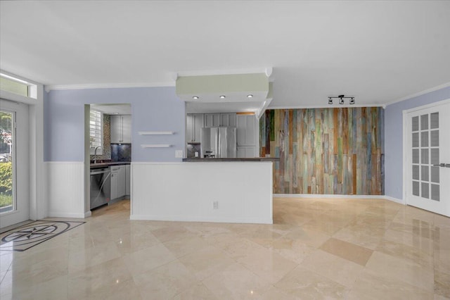 104 Paradise Harbour Blvd Unit 104, North Palm Beach, FL 33408 - kitchen featuring appliances with stainless steel finishes, ornamental molding, gray cabinets, a wainscoted wall, and a sink