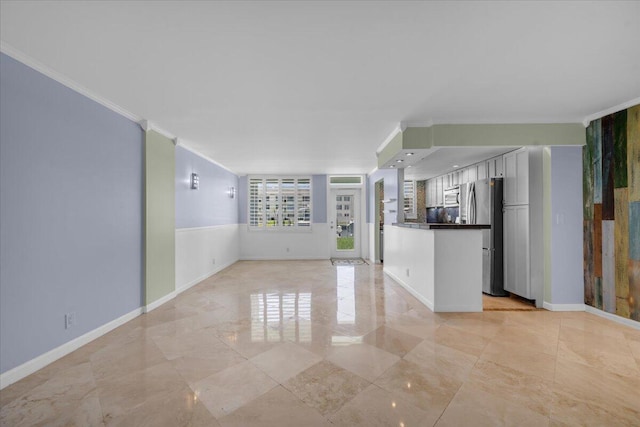 104 Paradise Harbour Blvd Unit 104, North Palm Beach, FL 33408 - unfurnished living room with crown molding