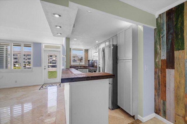 104 Paradise Harbour Blvd Unit 104, North Palm Beach, FL 33408 - kitchen featuring freestanding refrigerator, baseboards, recessed lighting, and a sink