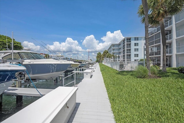 104 Paradise Harbour Blvd Unit 104, North Palm Beach, FL 33408 - dock area featuring boat lift and a yard