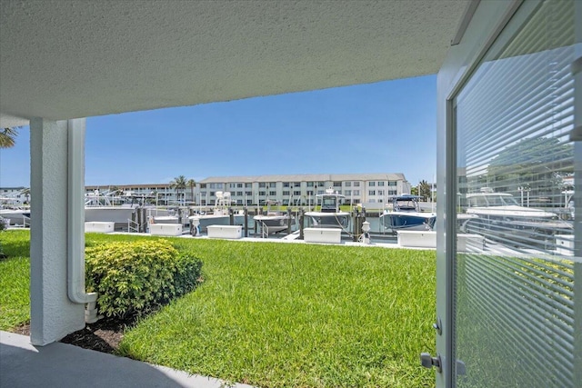 104 Paradise Harbour Blvd Unit 104, North Palm Beach, FL 33408 - view of grassy yard with a boat dock and boat lift