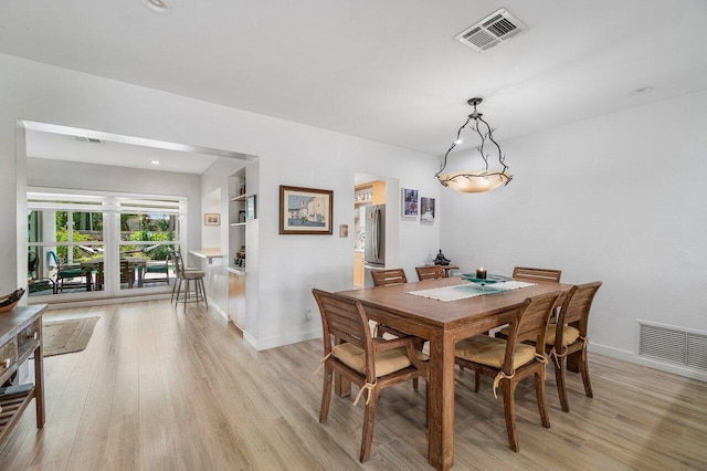 1222 N Palmway, Lake Worth Beach, FL 33460 - dining room with light wood-style flooring and baseboards