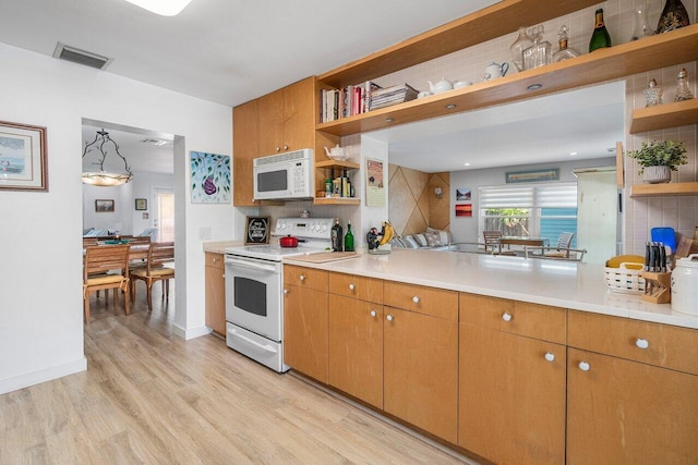 1222 N Palmway, Lake Worth Beach, FL 33460 - kitchen with open shelves, white appliances, light wood-type flooring, decorative backsplash, and light countertops