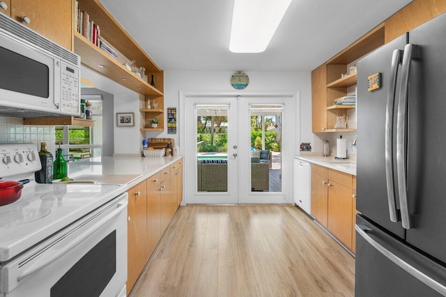 1222 N Palmway, Lake Worth Beach, FL 33460 - kitchen featuring white appliances, open shelves, light wood-style floors, french doors, and light countertops