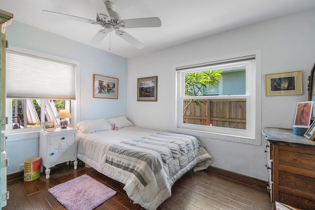 1222 N Palmway, Lake Worth Beach, FL 33460 - bedroom featuring multiple windows, hardwood / wood-style flooring, ceiling fan, and baseboards