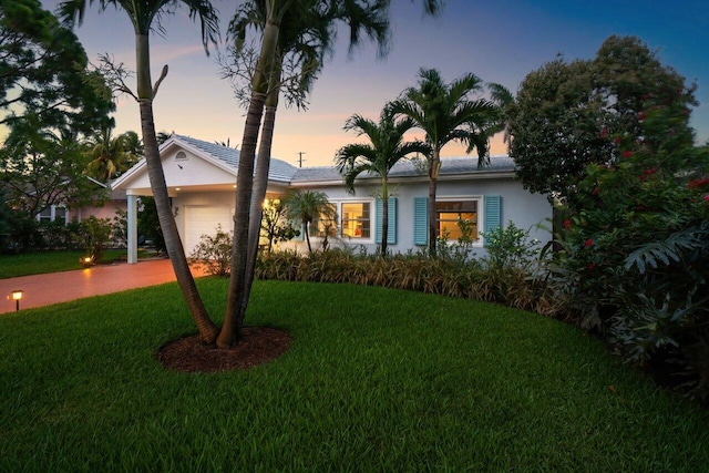 1222 N Palmway, Lake Worth Beach, FL 33460 - ranch-style house with stucco siding, a garage, and a yard