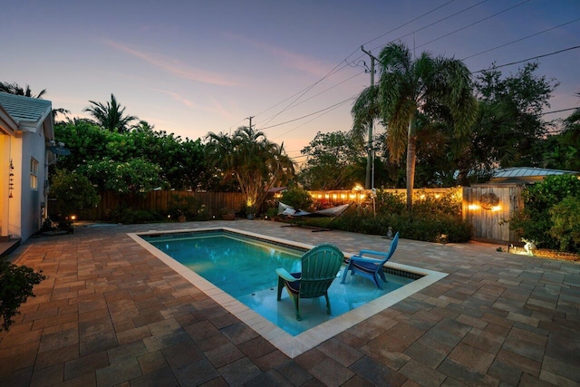 1222 N Palmway, Lake Worth Beach, FL 33460 - pool at dusk featuring a patio and a fenced backyard