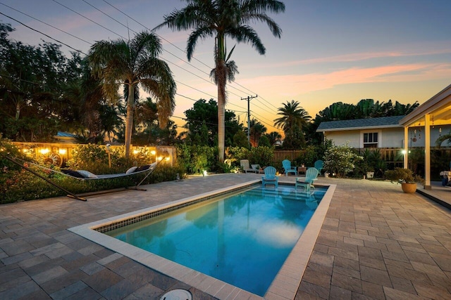 1222 N Palmway, Lake Worth Beach, FL 33460 - pool at dusk featuring a patio and an outdoor pool