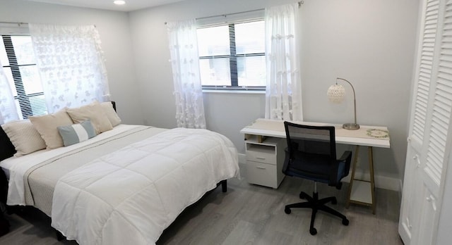 9740 Pecan Tree Dr Unit A, Boynton Beach, FL 33436 - bedroom featuring wood finished floors, multiple windows, baseboards, and an office area