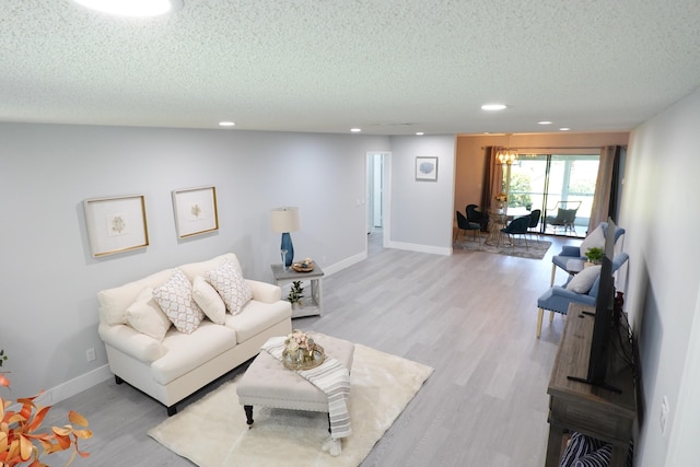 9740 Pecan Tree Dr Unit A, Boynton Beach, FL 33436 - living area with a textured ceiling, light wood finished floors, recessed lighting, and baseboards