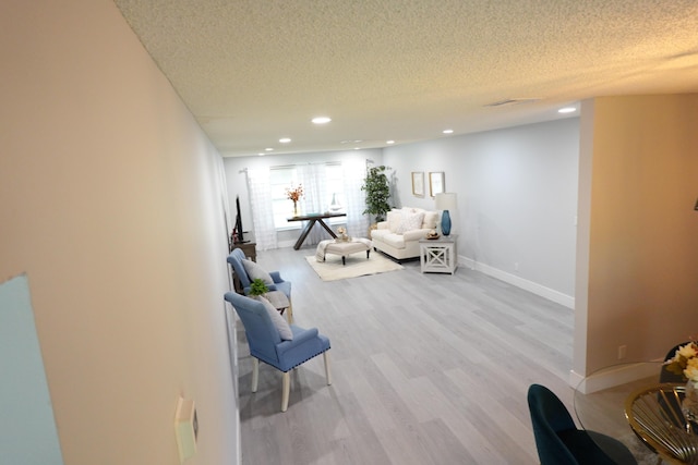 9740 Pecan Tree Dr Unit A, Boynton Beach, FL 33436 - living room featuring a textured ceiling, light wood-style floors, baseboards, and recessed lighting