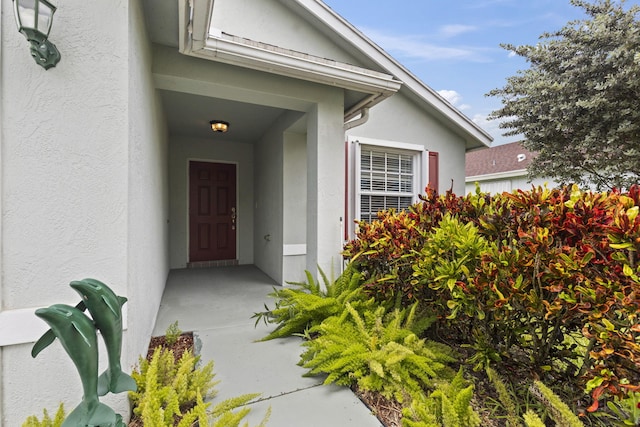 2683 SW Marquis Ter, Stuart, FL 34997 - obstructed view of property featuring stucco siding, driveway, a front yard, and an attached garage