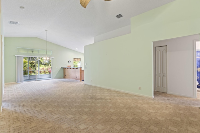2683 SW Marquis Ter, Stuart, FL 34997 - unfurnished living room featuring carpet floors, high vaulted ceiling, a chandelier, and a ceiling fan
