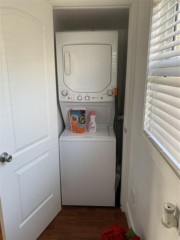 723 N Federal Hwy, Lake Worth Beach, FL 33460 - laundry room featuring stacked washer and clothes dryer and dark wood finished floors