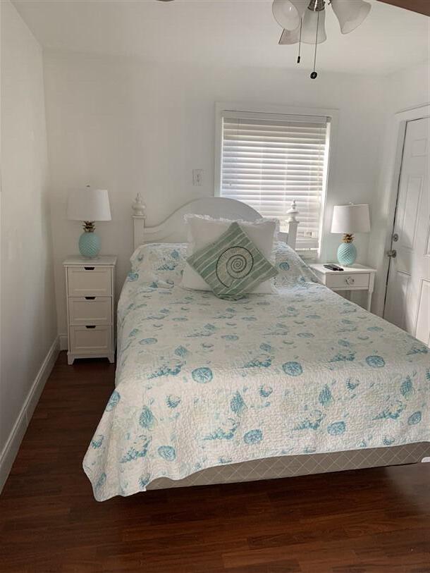 723 N Federal Hwy, Lake Worth Beach, FL 33460 - bedroom with dark wood finished floors, baseboards, and a ceiling fan