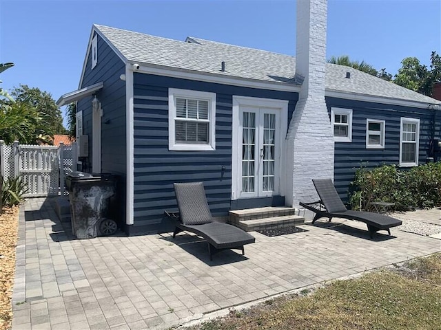 723 N Federal Hwy, Lake Worth Beach, FL 33460 - rear view of house with a patio area, french doors, a chimney, and a shingled roof