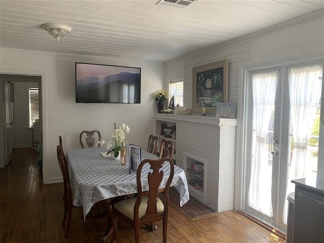 723 N Federal Hwy, Lake Worth Beach, FL 33460 - dining space featuring plenty of natural light, a fireplace, wood-type flooring, crown molding, and french doors