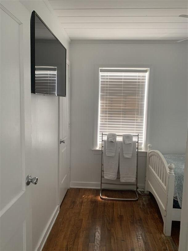 723 N Federal Hwy, Lake Worth Beach, FL 33460 - bedroom featuring wood finished floors, multiple windows, and baseboards