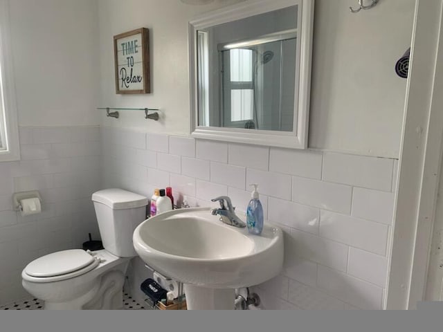 723 N Federal Hwy, Lake Worth Beach, FL 33460 - bathroom featuring tile walls, toilet, an enclosed shower, a sink, and a wainscoted wall